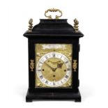 An 18th century and later ebonised quarter chiming table clock W Tomlinson London