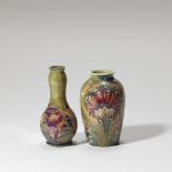 William Moorcroft Two 'Spanish' and 'Cornflower' miniature vases, circa 1910