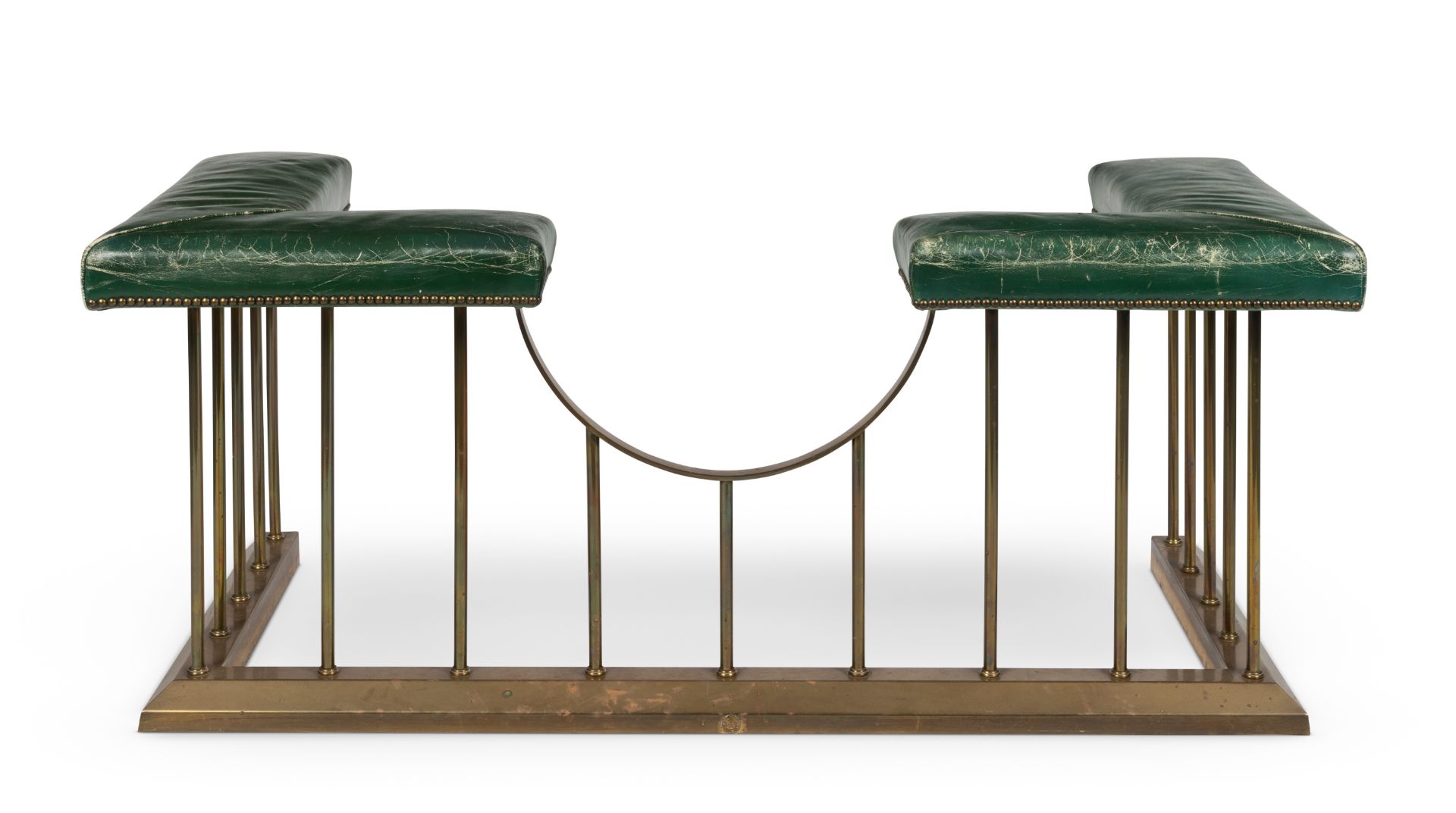 A brass and green leather upholstered club fender