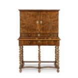 A William and Mary walnut oyster veneered cabinet on later stand