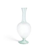 A Roman pale blue-green glass footed flask