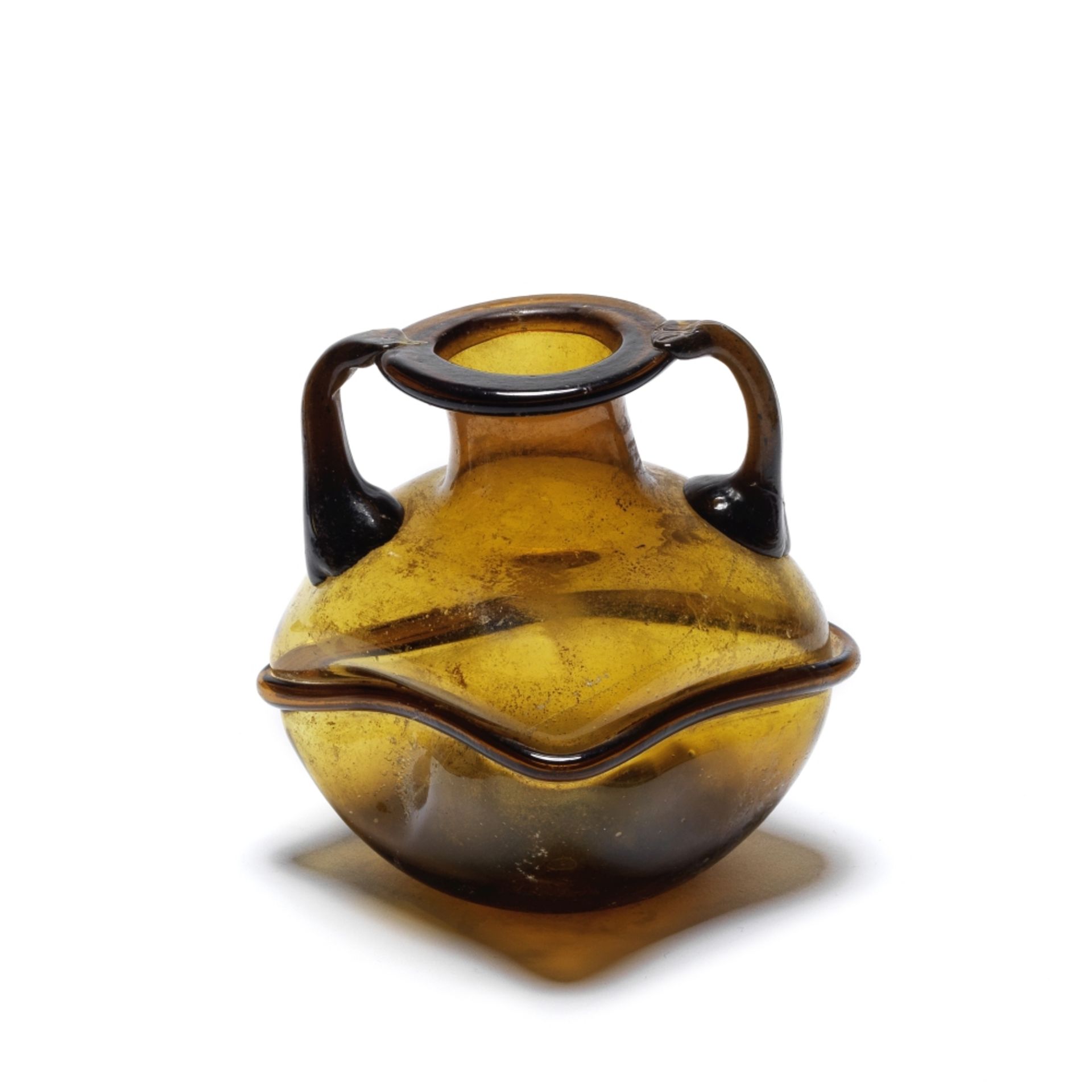 A Roman deep amber glass four-sided bottle