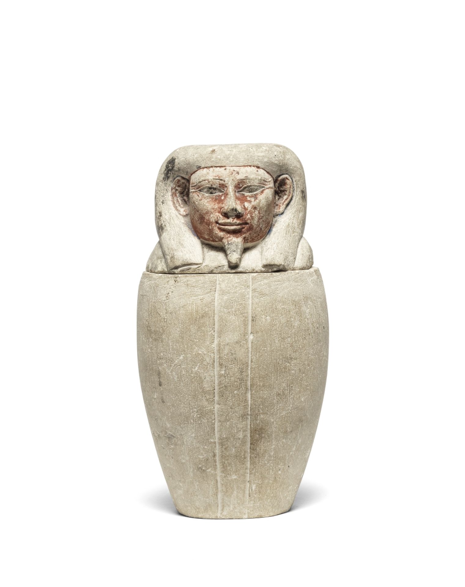 An Egyptian limestone canopic jar