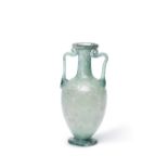 A Roman green glass footed amphoriskos