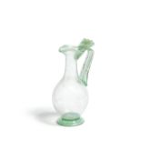 A Roman green glass trefoil-lipped jug