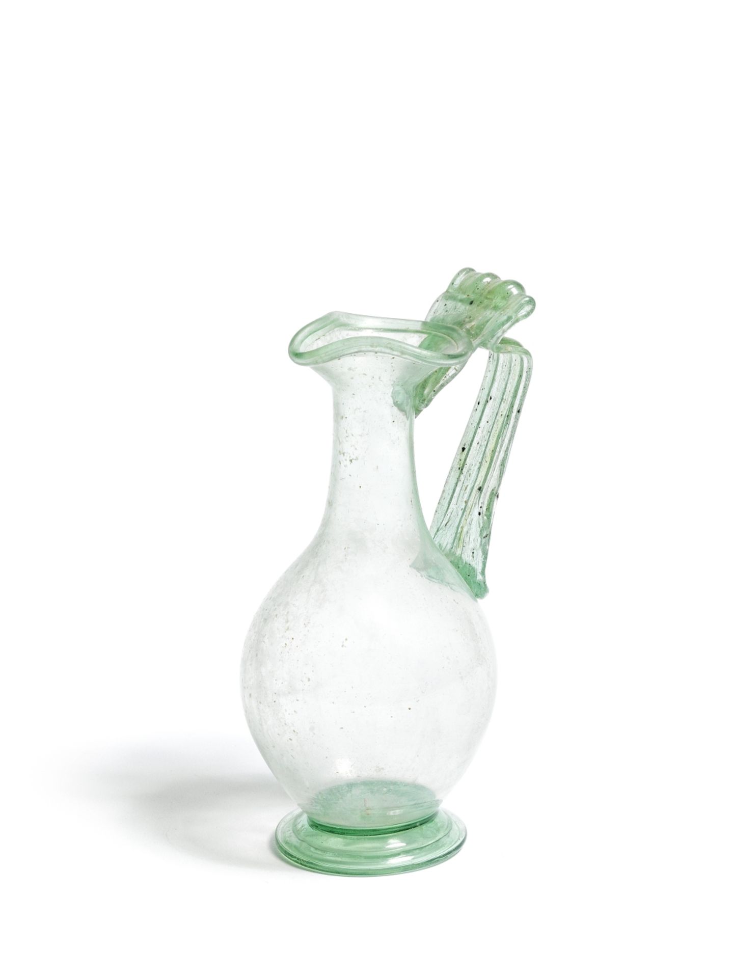 A Roman green glass trefoil-lipped jug