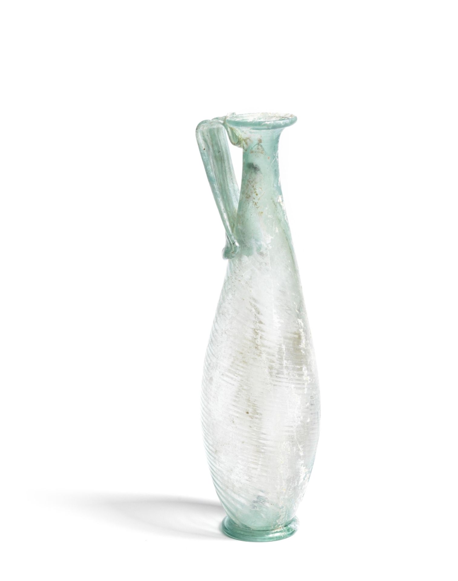 A tall slender Roman blue-green glass jug