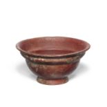 A Roman opaque red glass patella cup