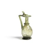 A Roman olive green glass jug