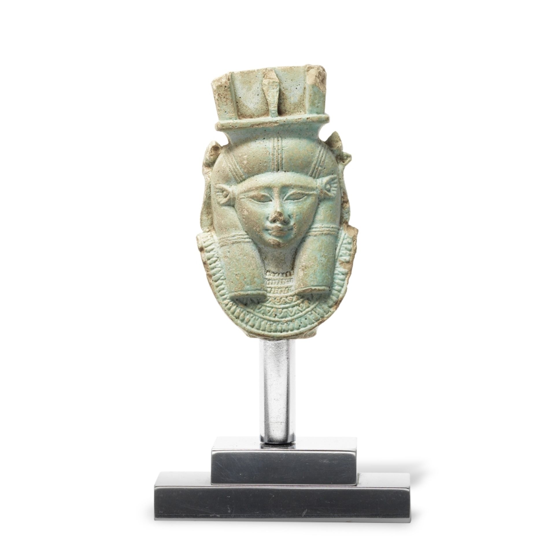 An Egyptian green glazed faience double-sided head of Hathor