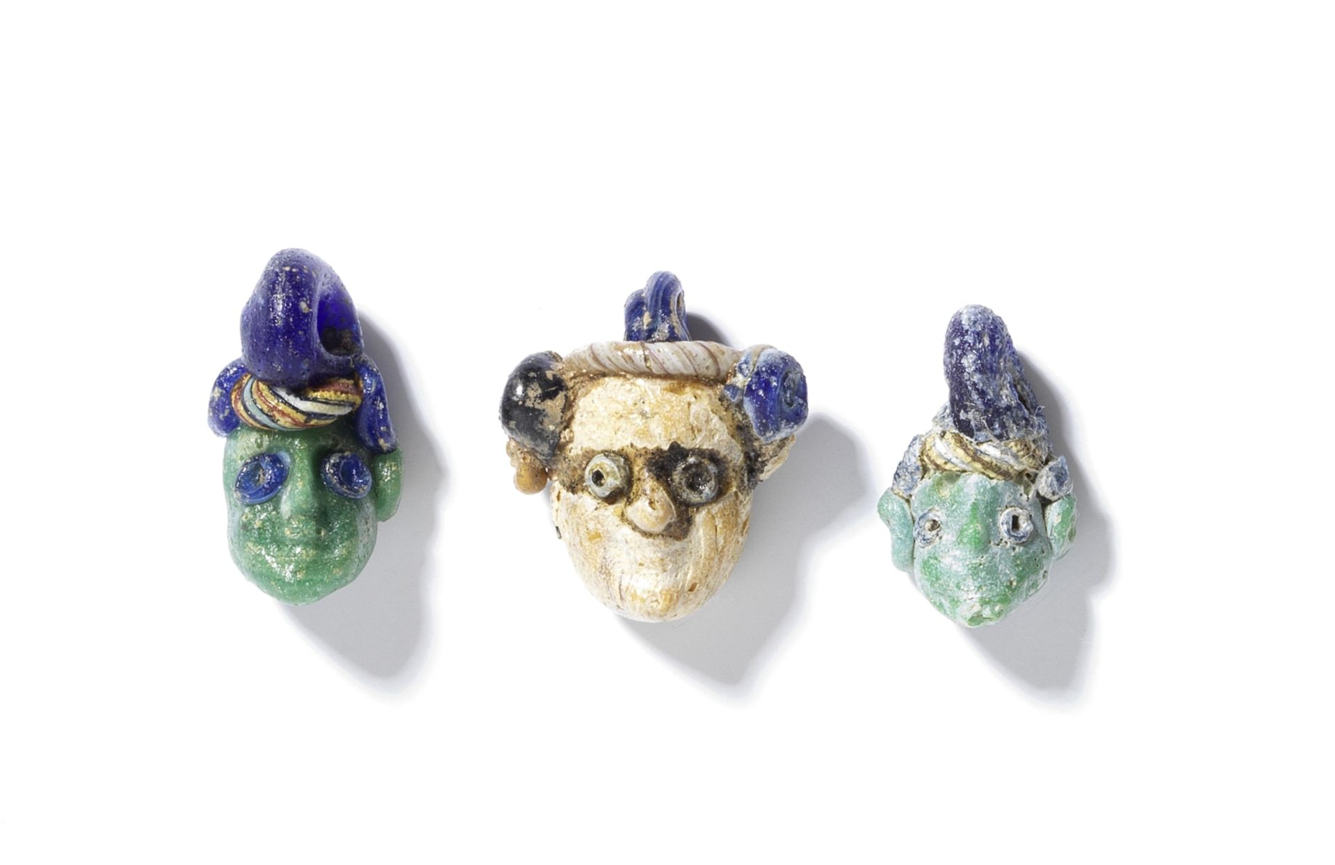 Three Phoenician glass head pendants 3