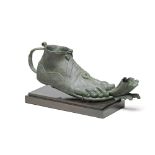 A large Roman bronze lamp in the form of a foot