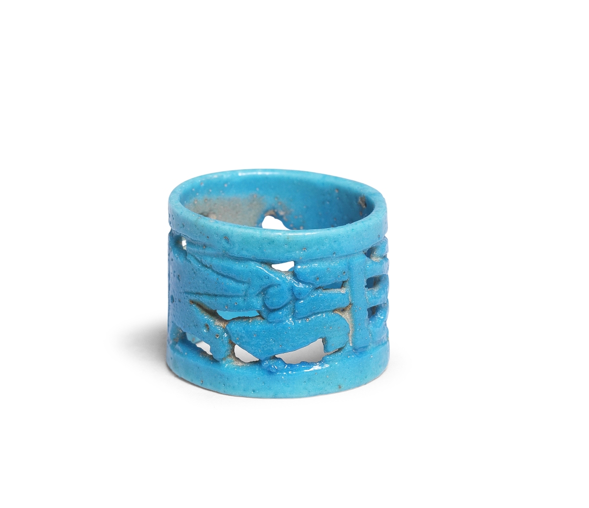 An Egyptian turquoise glazed faience openwork ring