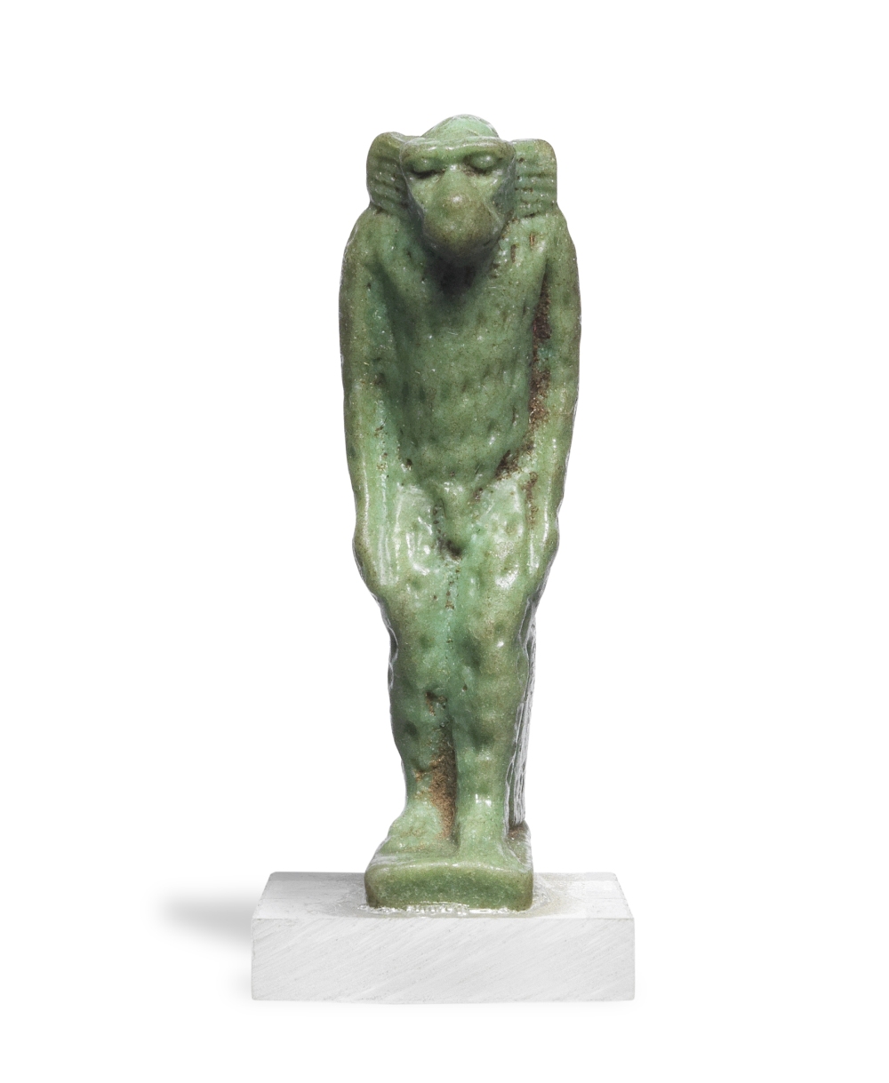 An Egyptian green glazed faience amulet of a vervet monkey
