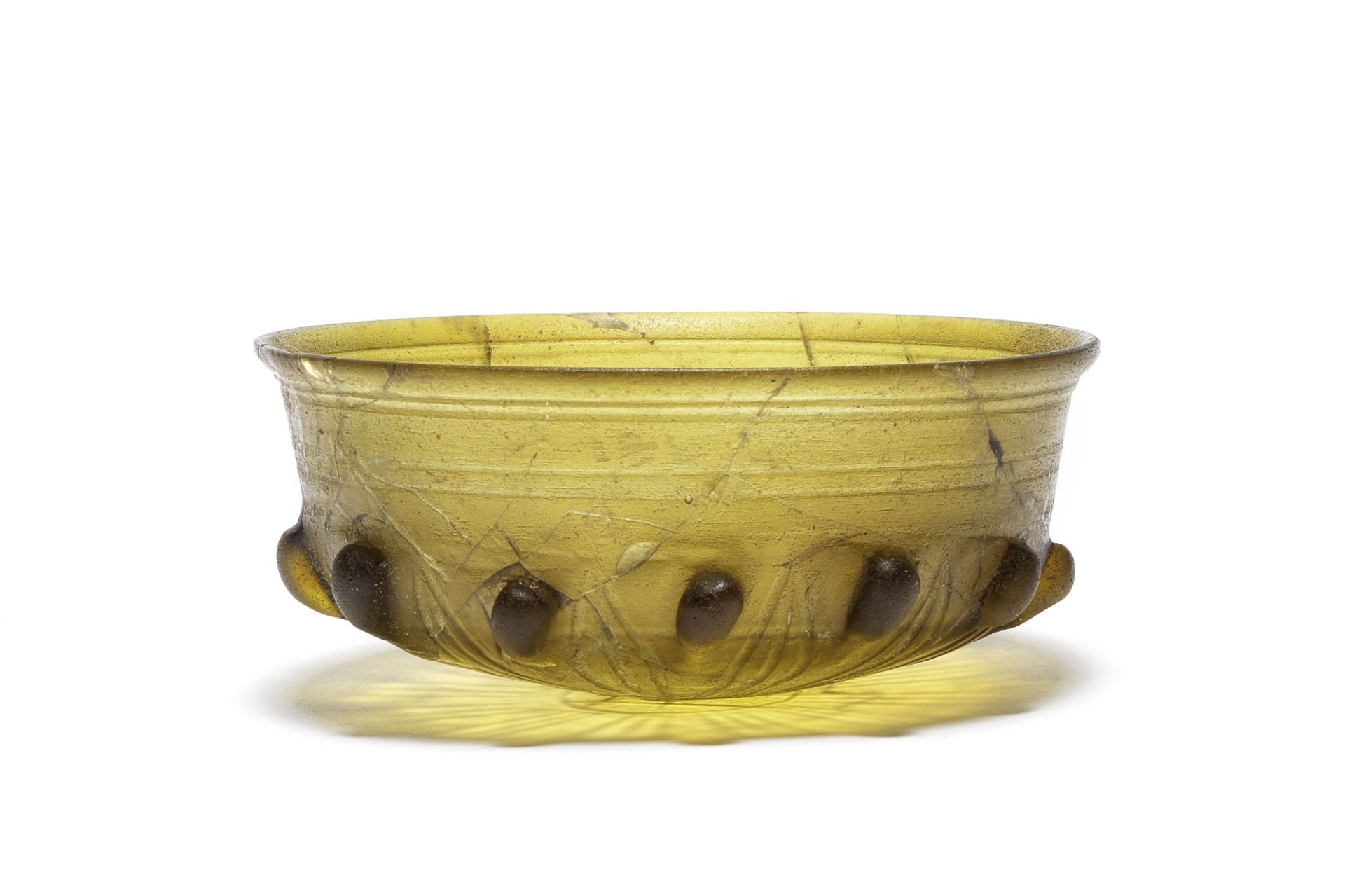 A Hellenistic amber-green cast glass lobed bowl