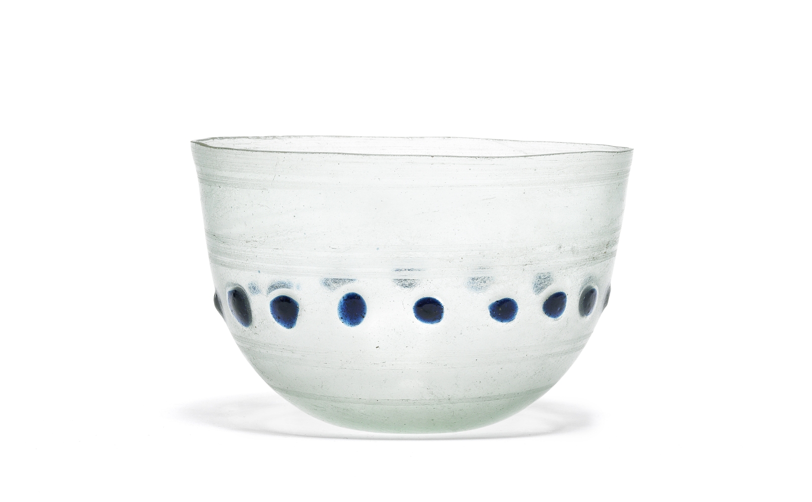 A Roman pale green glass hemispherical bowl