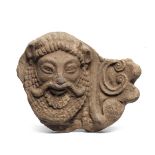 A fragmentary Etruscan terracotta antefix