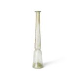 A tall Roman olive green glass unguentarium