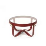 JACQUES ADNET Table bassecr&#233;ation circa 1940Cuir rouge, laiton et verreH: 43cm.(16 15/16in.)...