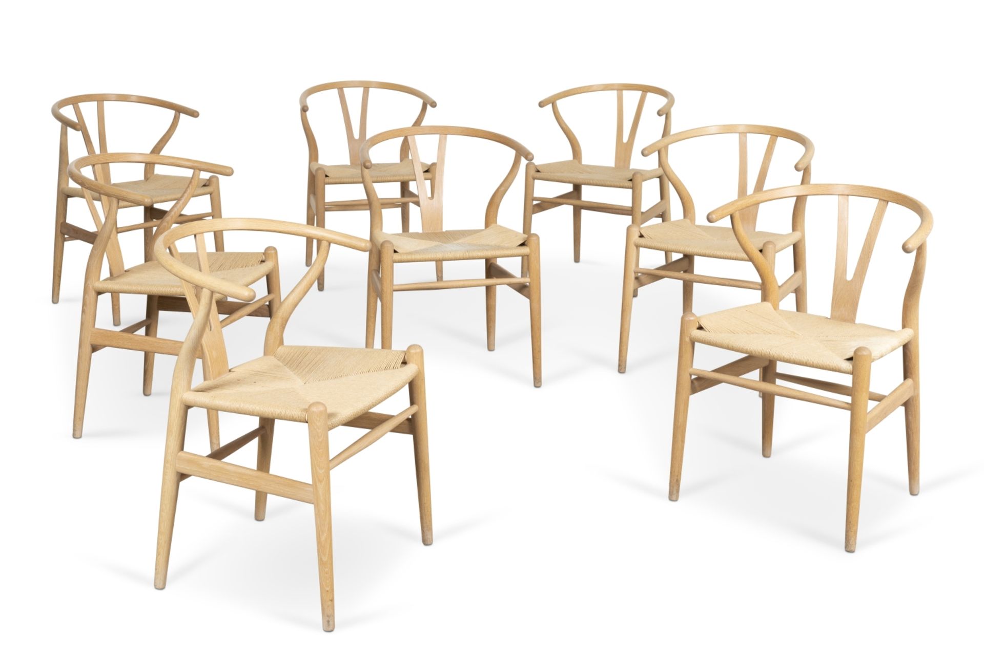 A set of eight CH24 'Wishbone' dining chairsDesigned by Hans J Wegner in 1949, manufactured by Ca...