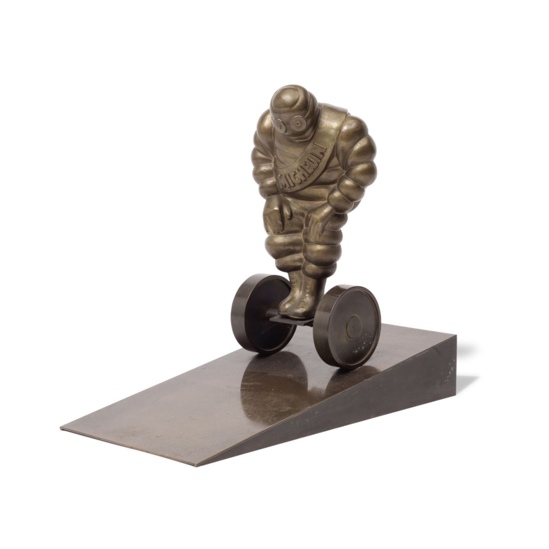 A bronze figural group of the Michelin Man