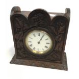 An Antique brass barrel clock [French] fitted within an Arts & Crafts hand carved wooden body. [20.