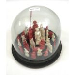 Antique Chinese hand carved figures fitted within a glass and wood dome display. [Some pieces loose]