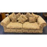 A Large Chesterfield style lounge sofa, designed with feathered cushions.
