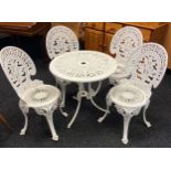 A Cast metal garden table and four chairs.