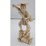A large 19th century Japanese Ivory figure of an elderly gentleman and child. Signed to the base. [