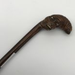 A 19th century walking cane with a hand carved monkey head handle. Fitted with glass eyes. [89cm