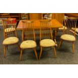 An Ercol extendable dining table with 6matching spindle back chairs. [76x137x84cm]