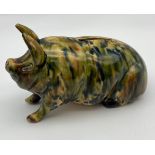 A Scottish pottery pig moneybox by Morrison & Crawford, Kirkcaldy. C1890. Covered in mottled glazes,