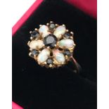 A Ladies 9ct yellow gold opal and sapphire floral design ring. [Ring size][3.27grams]