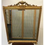 A Heavy antique Regency style wall mirror, designed with a gilt urn finial and scrolls. [71x52cm]