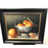 A Reproduction print on canvas after Robert Ritchie, depicts still life oranges in a bowl. Fitted
