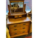 Late 19th century dressing table, the swivel mirror, flanked by art nouveau design supports, above a