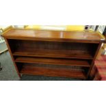 19th century bookcase, applied brass gallery to the top above three long shelves, raised on square