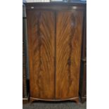 Victorian bow front wardrobe, the top with a moulded edge above two doors leading to interior,