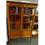 Georgian style bookcase, the top with a moulded edge, above two glass and moulded design doors,