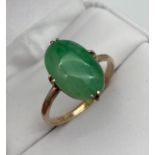 An 18ct gold and jade stone ring. [2.87grams] [Ring size O] [14.4x9.2x4.1mm- stone]