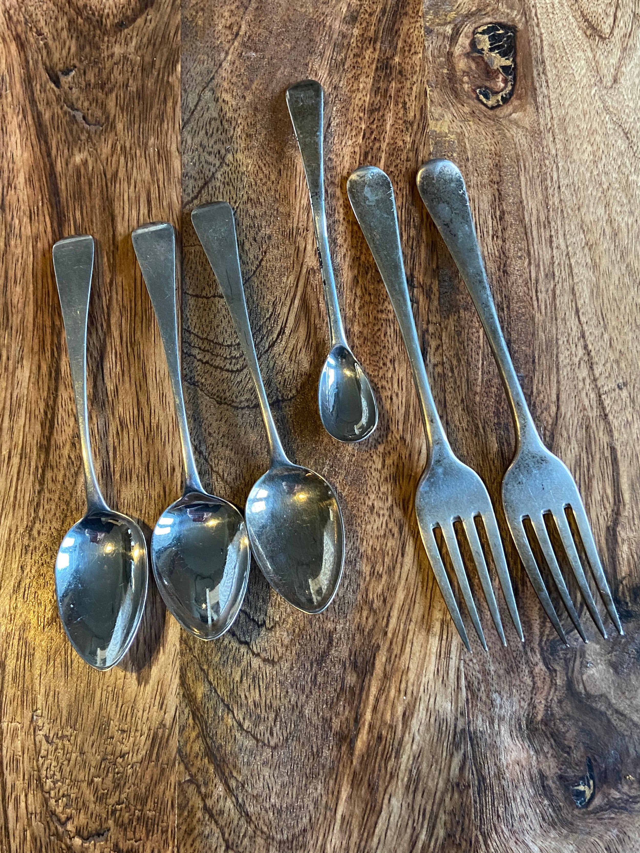 A Selection of Georgian silver flatwares to include desert forks and tea spoons. [Total weight