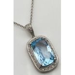 A 9ct white gold large blue stone & diamond cluster pendant with a 9ct white gold necklace [length