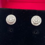 A Pair of 9ct white gold diamond stud earrings. [0.25ct diamonds]