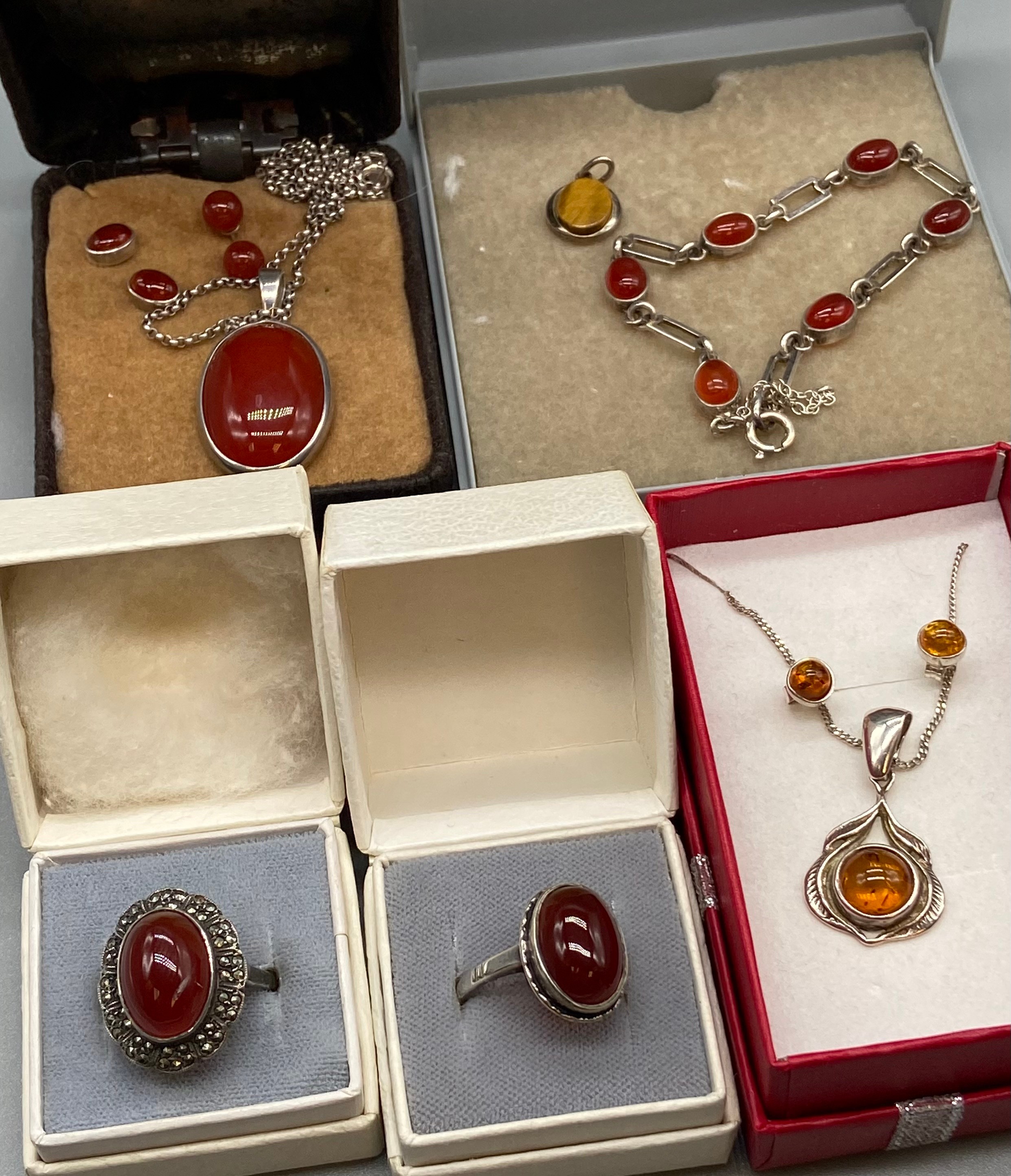 A Selection of Amber and Red stone silver jewellery to include Rings, bracelets and earring sets