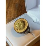 A Gold George V 1913 Half soveriegn coin fitted within a 9ct gold ring. [Ring size K] [7.77Grams]