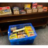 A Box containing a large collection of boxed car models includes James Bond, Shell and Matchbox