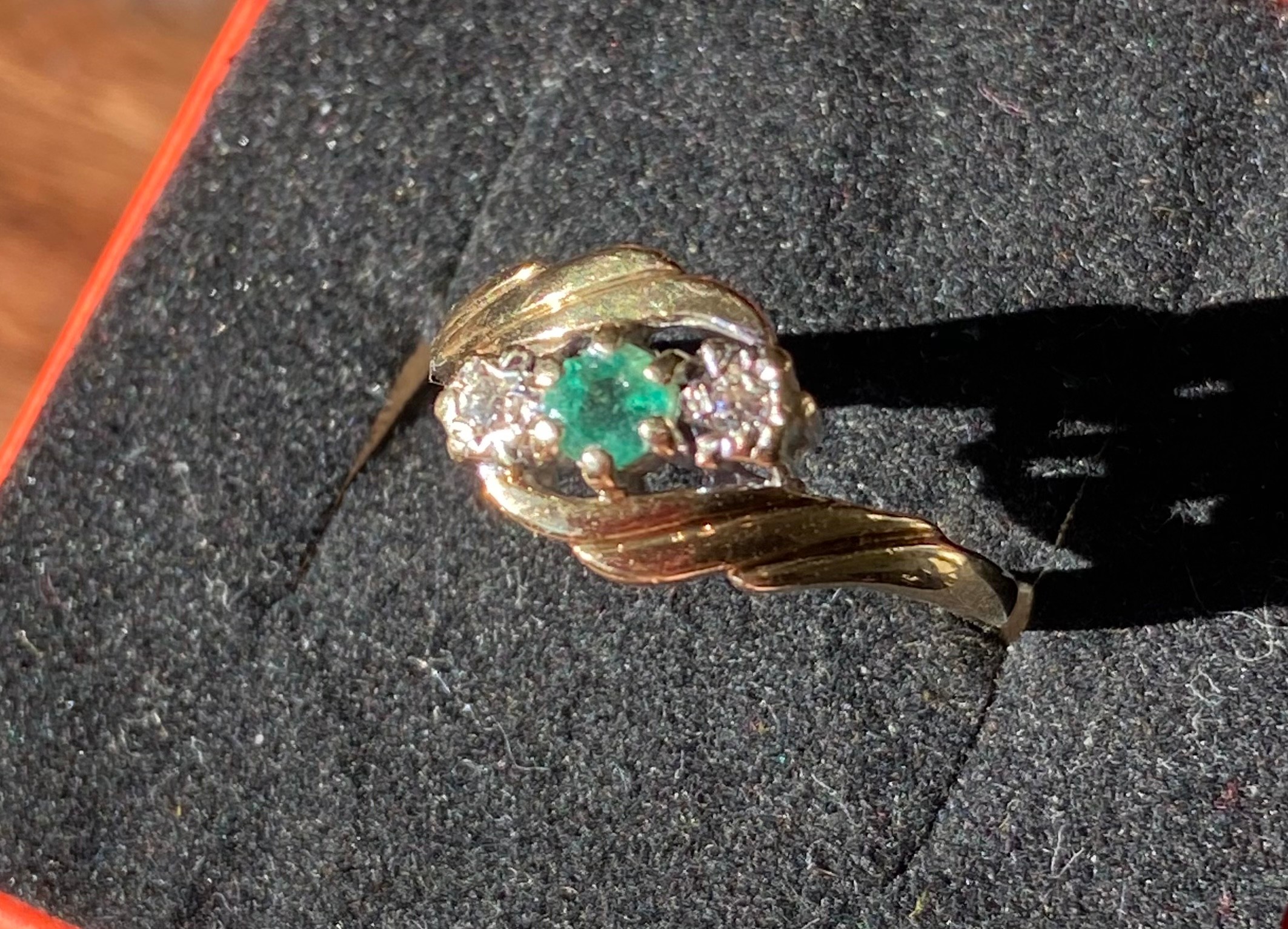 An 9ct yellow gold ladies ring set with a single emerald and two single diamonds [Ring size L] [2.