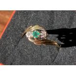 An 9ct yellow gold ladies ring set with a single emerald and two single diamonds [Ring size L] [2.