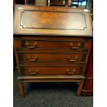 Reproduction writing desk, the sloped front pulling down to a leather covered writing surface and